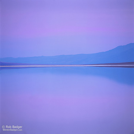 Reflections in flooded salt flats under blue twilight_badwater_Death Valley National Park_California_Rob Badger