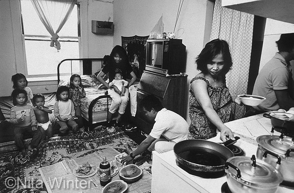 Cambodian family eating dinner in tiny apartment in San Francisco's Tenderloin District