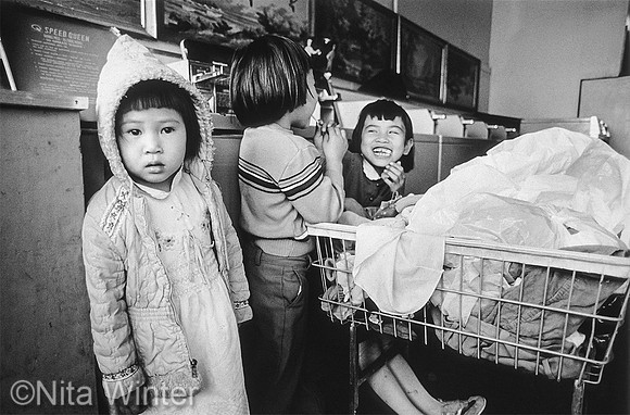 Girls laughing in laundry mat Tenderloin San Francisco